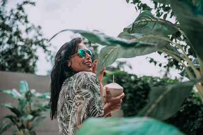 Young woman drinking water from coffee