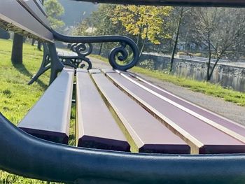 Empty park bench on field