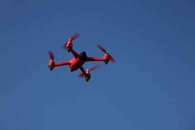 Red drone on a blue sky background