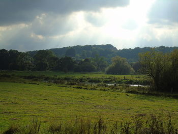 Scenic view of landscape against cloudy sky