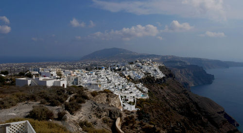 High angle view of buildings by sea against sky