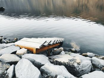 High angle view of rocks in lake during winter