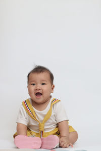 Portrait of cute baby against white background