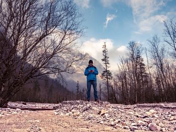 Man standing on field against sky