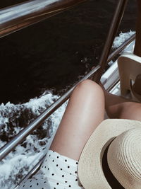 Low section of woman sitting in bus