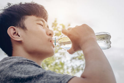Close-up of boy drinking glass with water