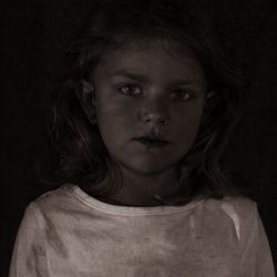 Portrait of girl against black background