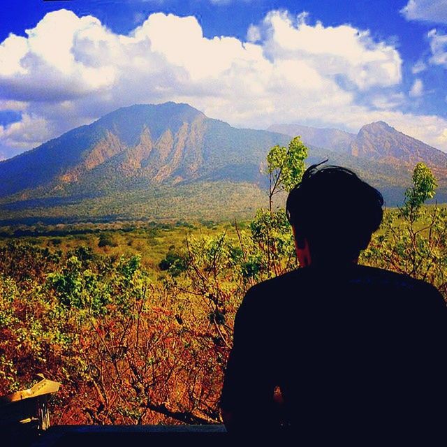 mountain, mountain range, sky, landscape, tranquility, tranquil scene, beauty in nature, scenics, rear view, nature, cloud - sky, lifestyles, standing, men, leisure activity, non-urban scene, cloud, field