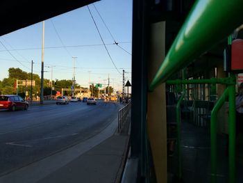 Cars on road in city against sky