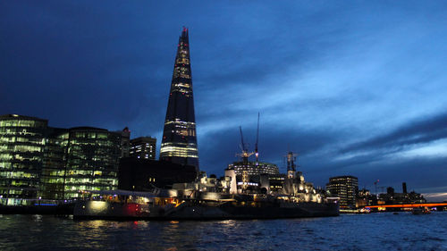 View of illuminated buildings in city at waterfront