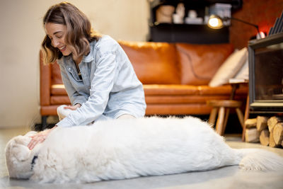 Woman with dog sitting at home