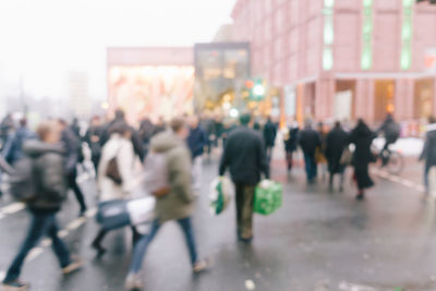 Crowd walking on street in city