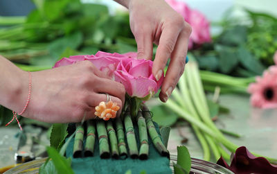 Close-up of florist making bouquet at table