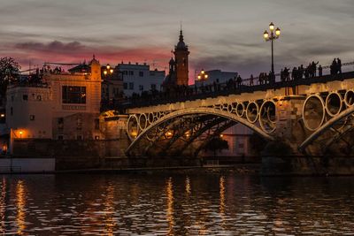 View of bridge over river at dusk