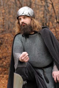 Man in costume standing at forest