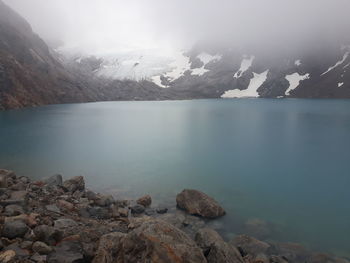 Scenic view of lake and mountains against sky