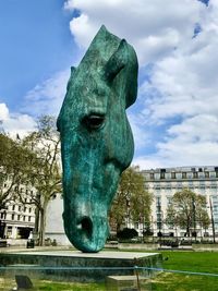 Statue against sky in city