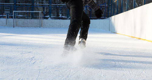 Low section of woman ice skating 