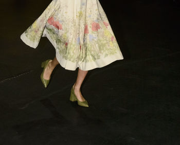 Low section of woman standing on tiled floor