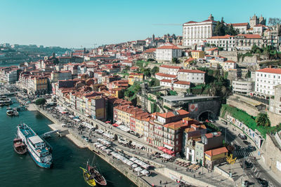 High angle view of boats moored on douro river by buildings against sky