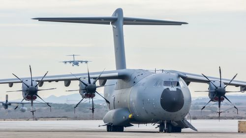 Airplane on airport runway against sky