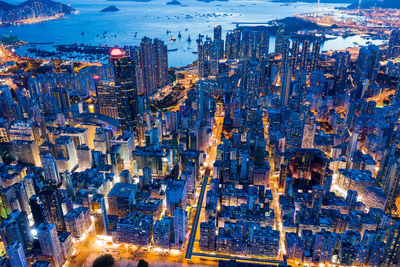 High angle view of city lit up at night