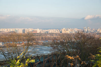 Scenic view of lake and buildings against sky