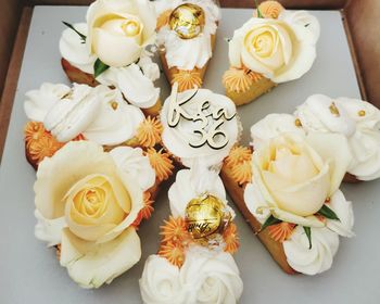 High angle view of white roses on table