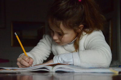 Girl doing homework at table