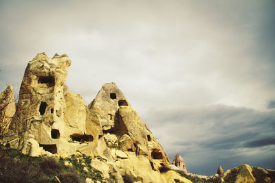 Uchisar castle against cloudy sky