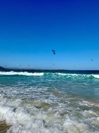 Scenic view of sea against clear blue sky