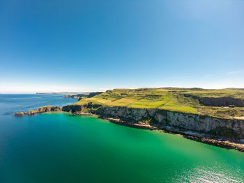 Scenic view of sea against blue sky