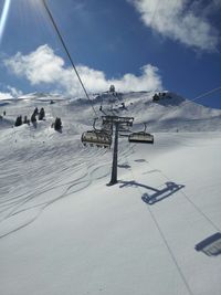 Overhead cable cars on snow covered ground