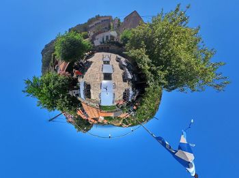 Low angle view of buildings against clear blue sky