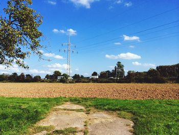 Scenic view of field against cloudy sky