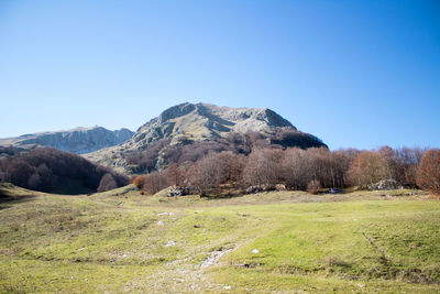Scenic view of mountains against clear blue sky