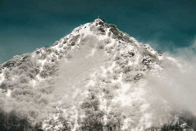 First snow on the mountain peak with cross winter mood image