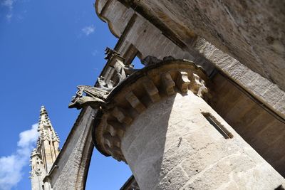 Low angle view of sculptures on building against sky