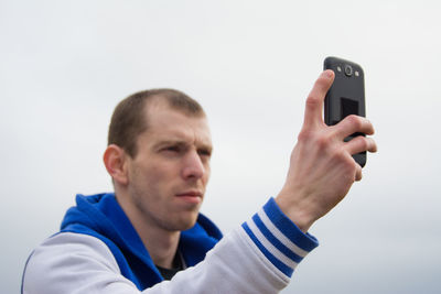 Close-up of man using mobile phone
