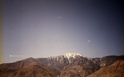 Scenic view of mountains against clear sky at night