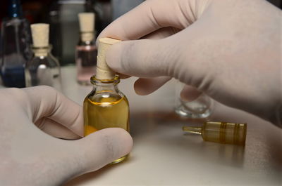 Close-up of hand holding bottle