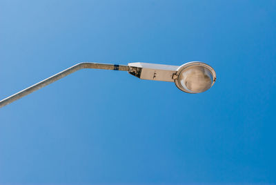 Low angle view of street light against clear blue sky