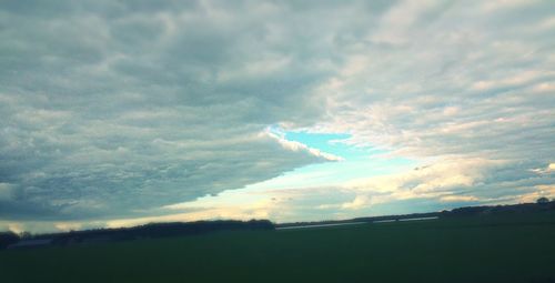 Scenic view of landscape against cloudy sky