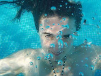 Close-up of woman underwater in swimming pool