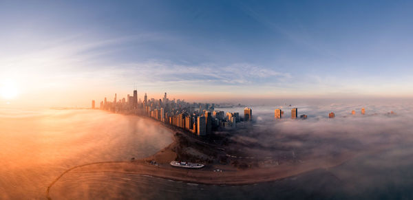 Panoramic view of city at sunset