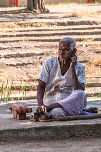 Full length of a man sitting outdoors