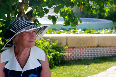 Woman standing on tree trunk
