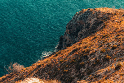 High angle view of rock formations by sea