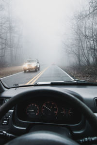 Car on road seen through windshield