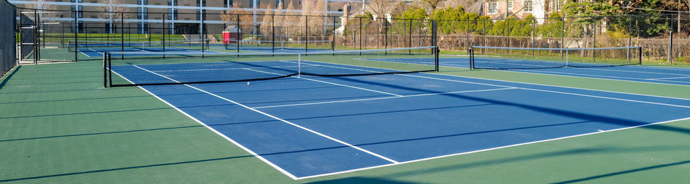 View of empty tennis courts against 